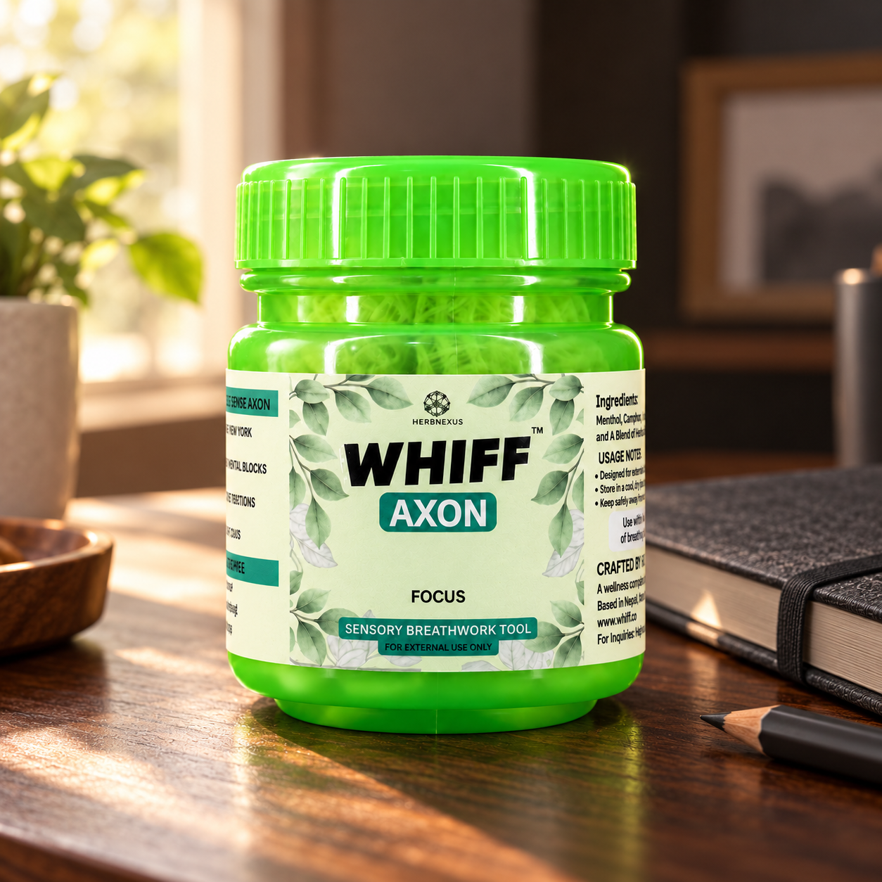 WHIFF AXON jar beside a notebook on a sunlit desk